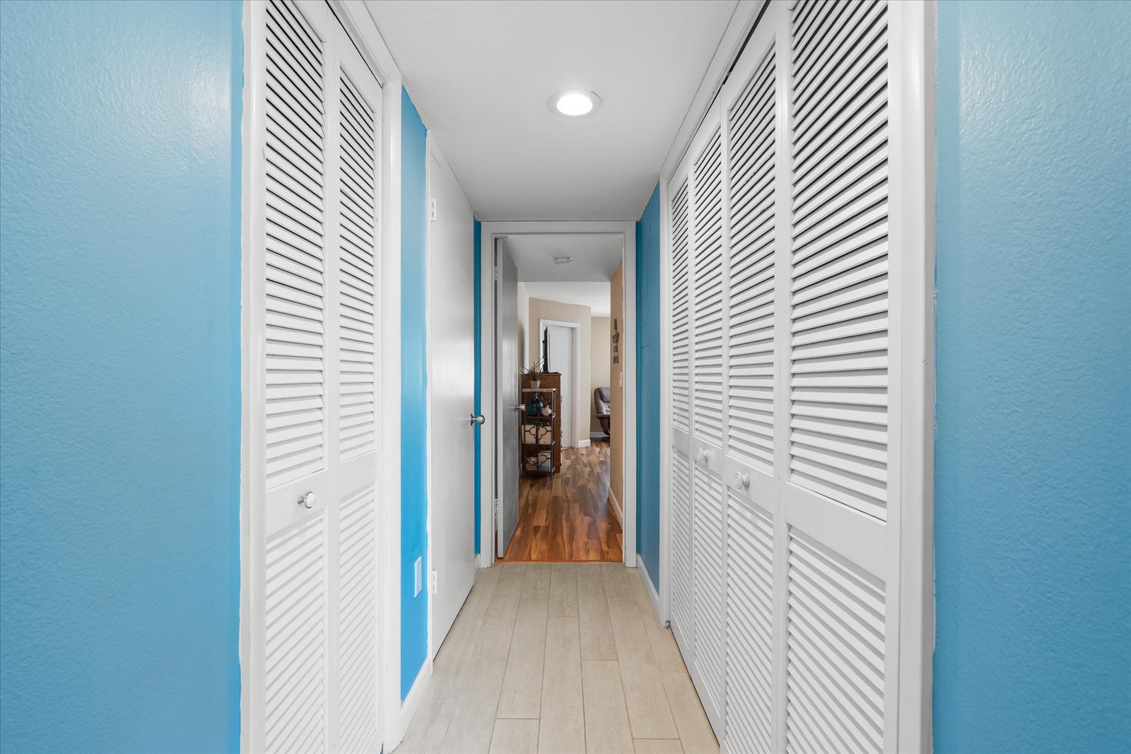 coastal themed living room with smart TV and sliding doors to the waterfront balcony